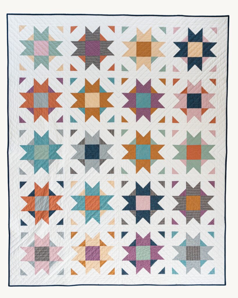 Flat lay photo of Compass Star Wildflower Wovens quilt.