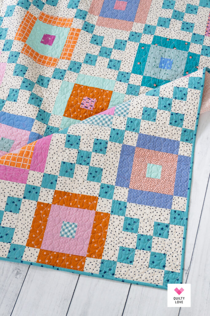 Lucky Links quilt on a white wooden floor.