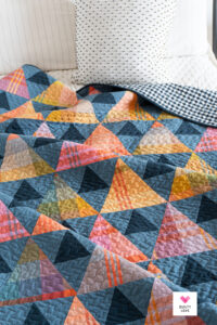 Modern plaid triangle quilt made with the Quilty Love Triangle Peaks quilt pattern.