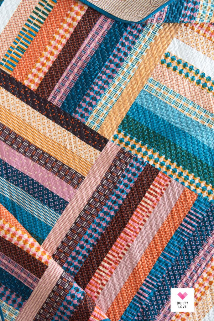 Vibrant patchwork quilt with geometric patterns and bright colors.