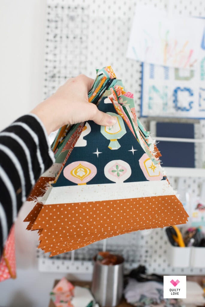 Someone is holding a stack of triangles for quilting