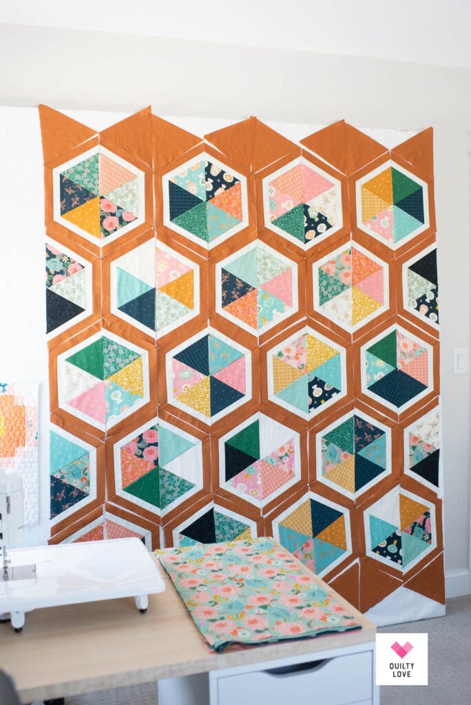 A Triangle hexies quilt top on a design wall