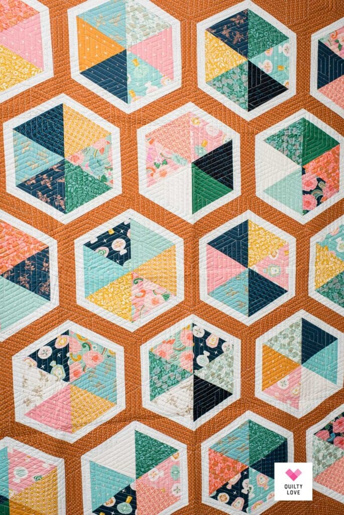 A Triangle Hexies quilt sewn up in Ruby Star Society fabric